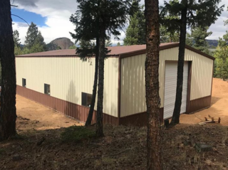 Metal frame garage workshop with corrugated steel